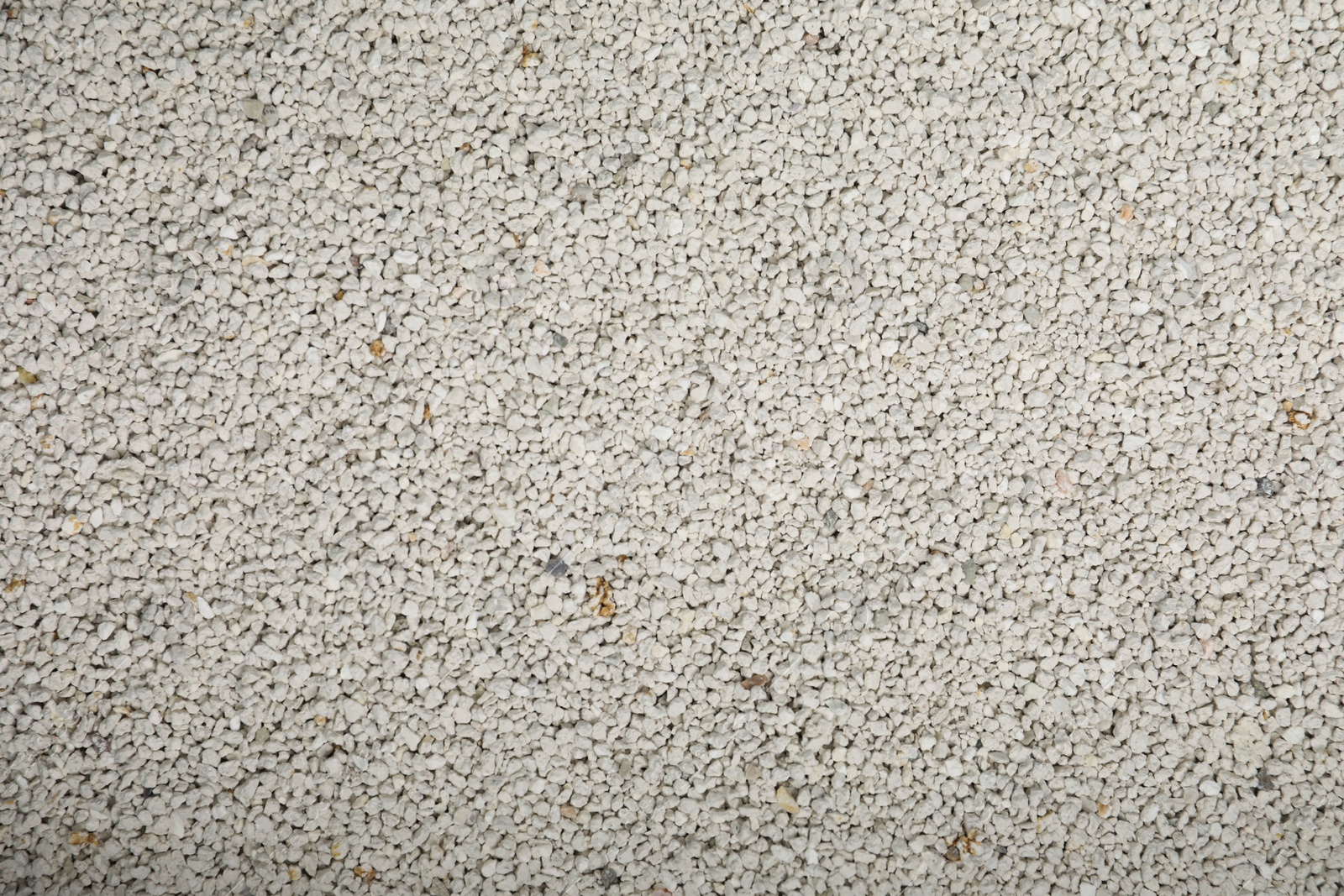 Photo of Clean clay cat litter as background, top view