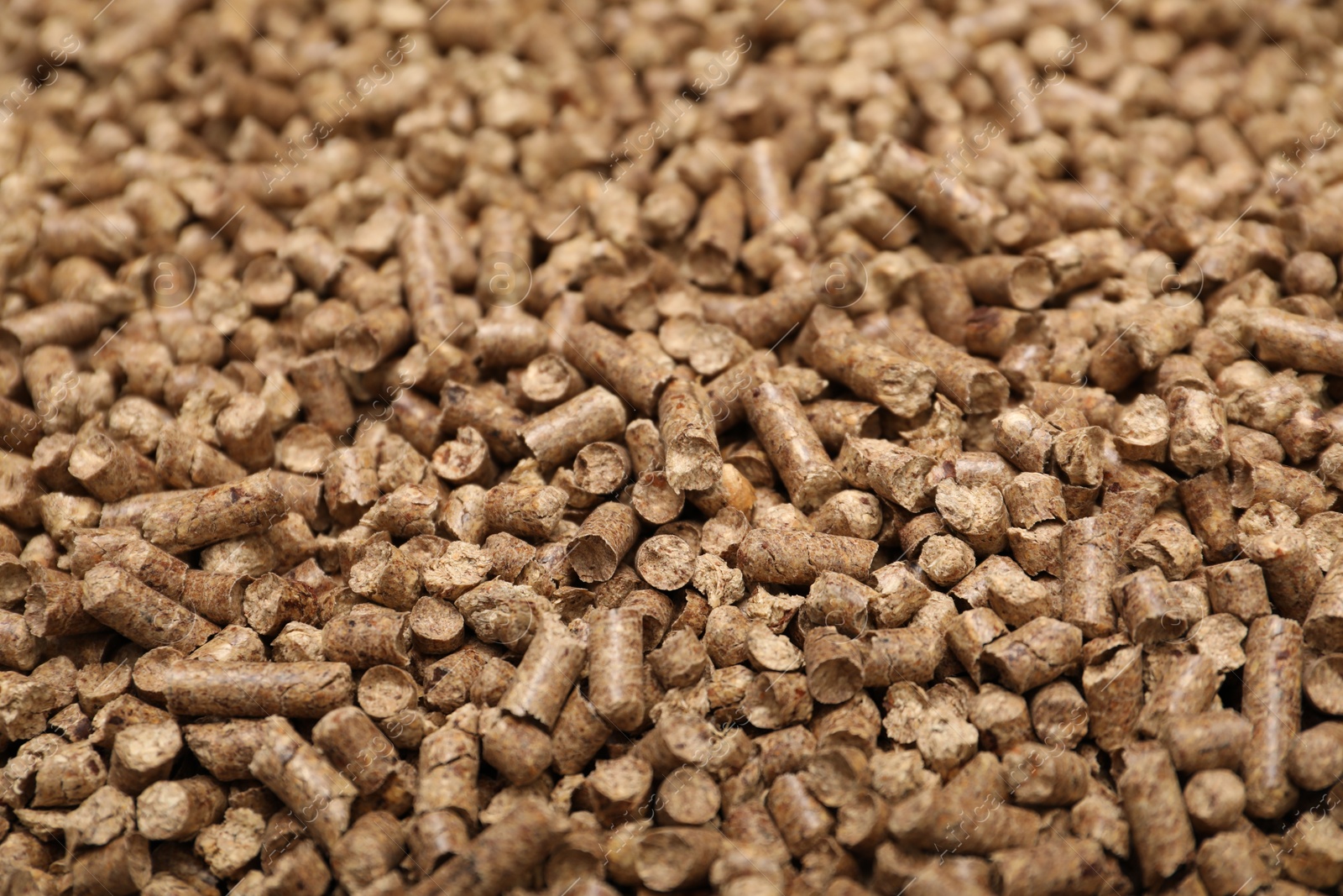 Photo of Wood pellet cat litter as background, closeup