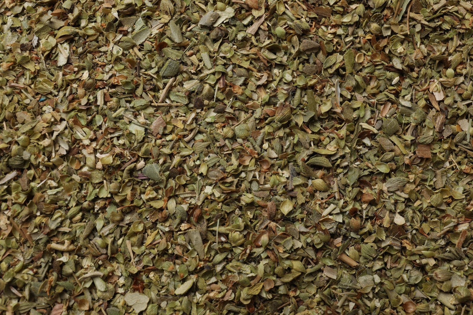 Photo of Dried oregano as background, top view. Aromatic herb