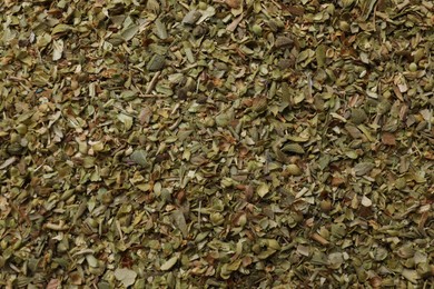 Photo of Dried oregano as background, top view. Aromatic herb