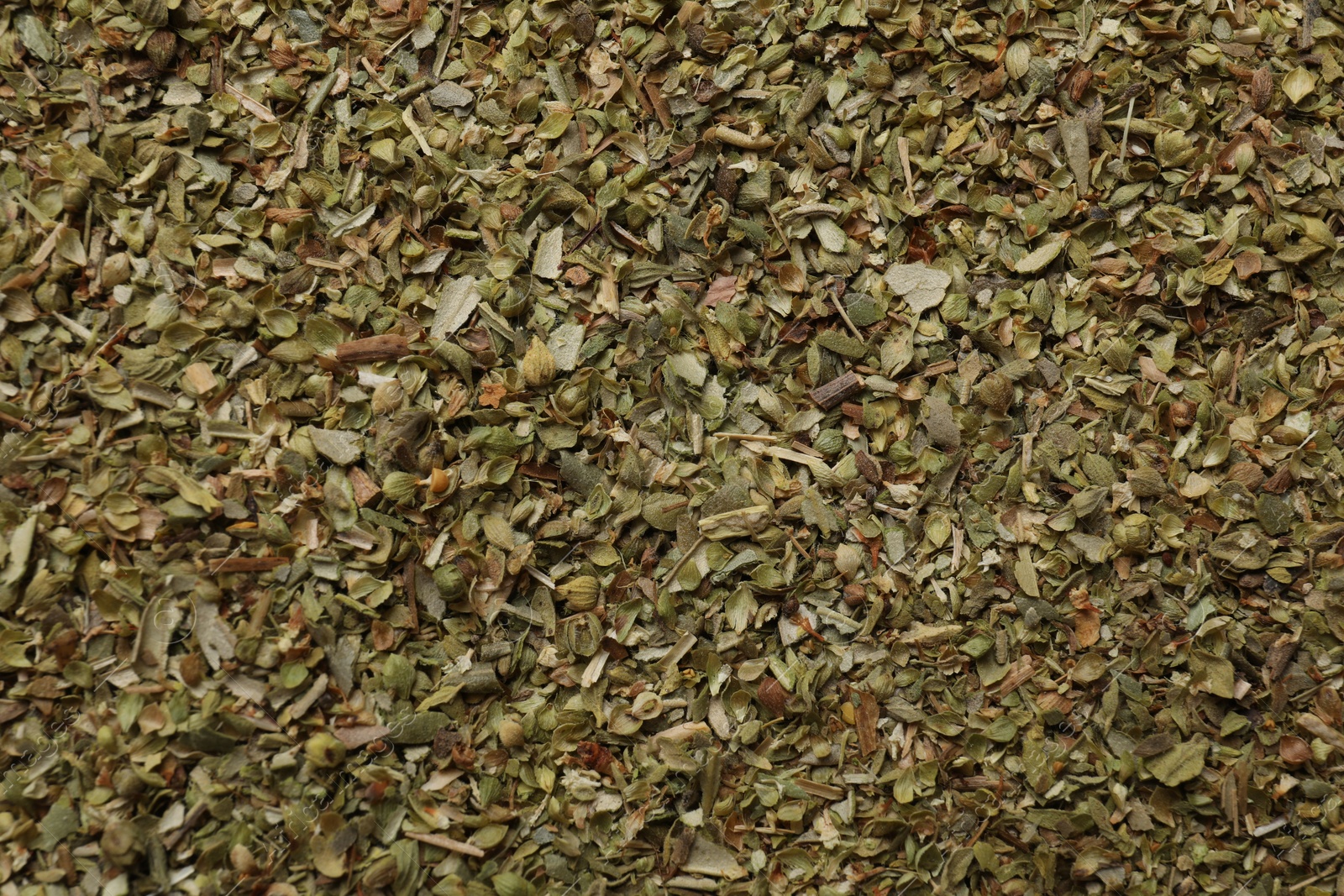 Photo of Dried oregano as background, top view. Aromatic herb