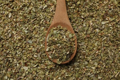 Photo of Dried oregano and wooden spoon, top view