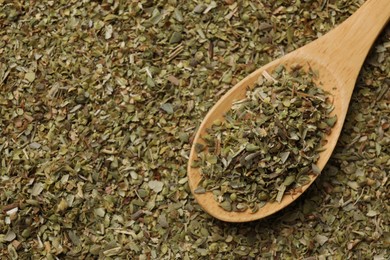 Photo of Dried oregano and wooden spoon, top view