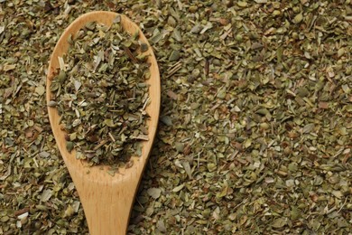 Photo of Dried oregano and wooden spoon, top view