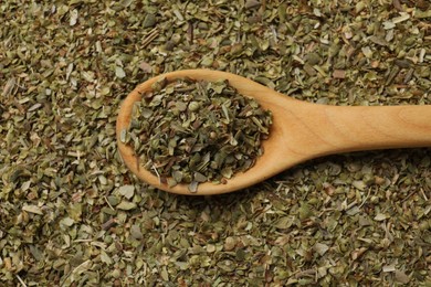 Photo of Dried oregano and wooden spoon, top view