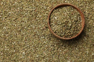 Dried oregano and wooden bowl, top view