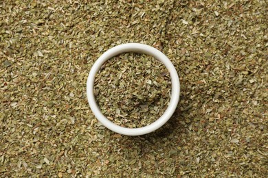 Photo of Dried oregano and bowl, top view. Healthy herb