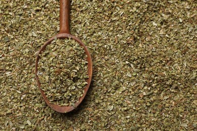 Photo of Dried oregano and wooden spoon, top view