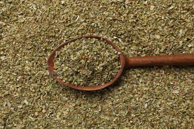 Dried oregano and wooden spoon, top view