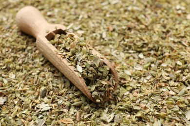 Photo of Dried oregano and wooden scoop, closeup view