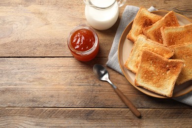 Photo of Delicious toasts served on wooden table, flat lay. Space for text