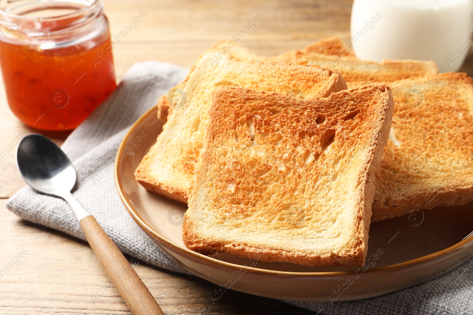 Photo of Delicious toasts served on wooden table, closeup