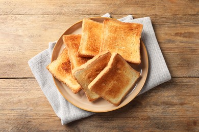 Delicious toasts on wooden table, top view