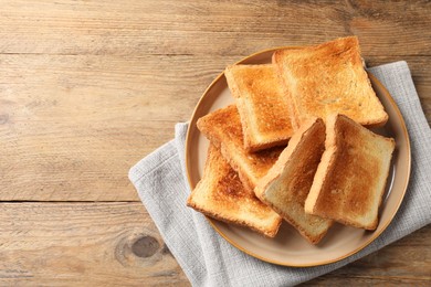 Photo of Delicious toasts on wooden table, top view. Space for text