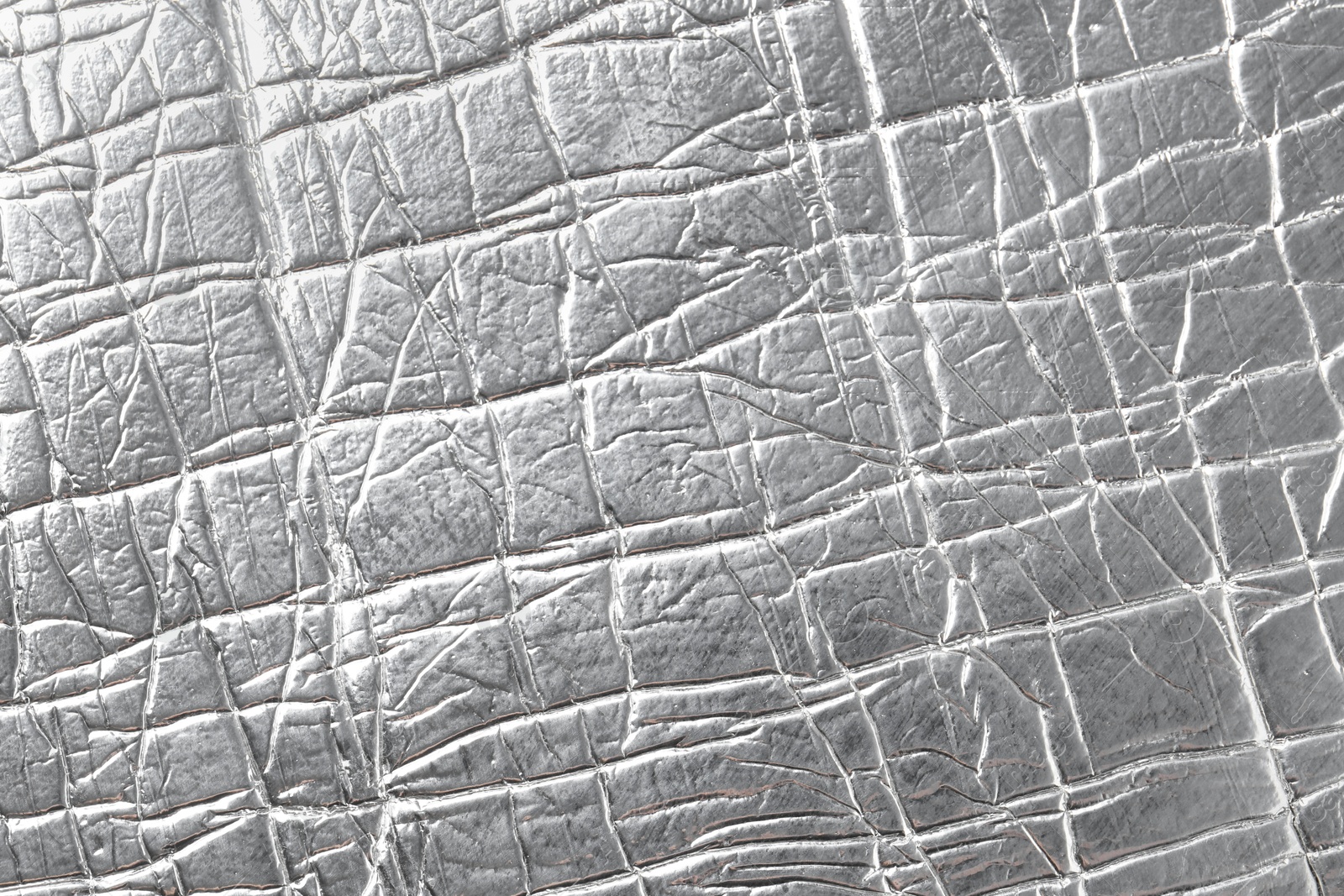 Photo of Shiny silver surface as background, closeup view