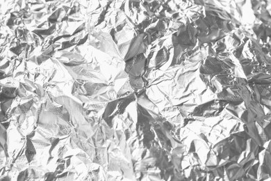 Photo of Shiny silver tinfoil surface as background, closeup