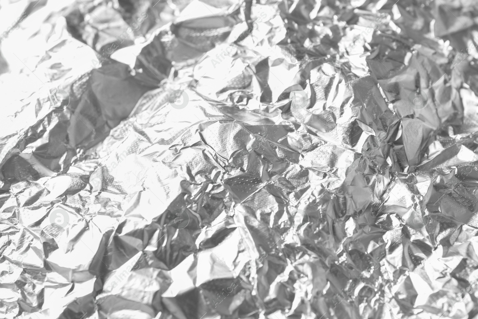 Photo of Shiny silver tinfoil surface as background, closeup