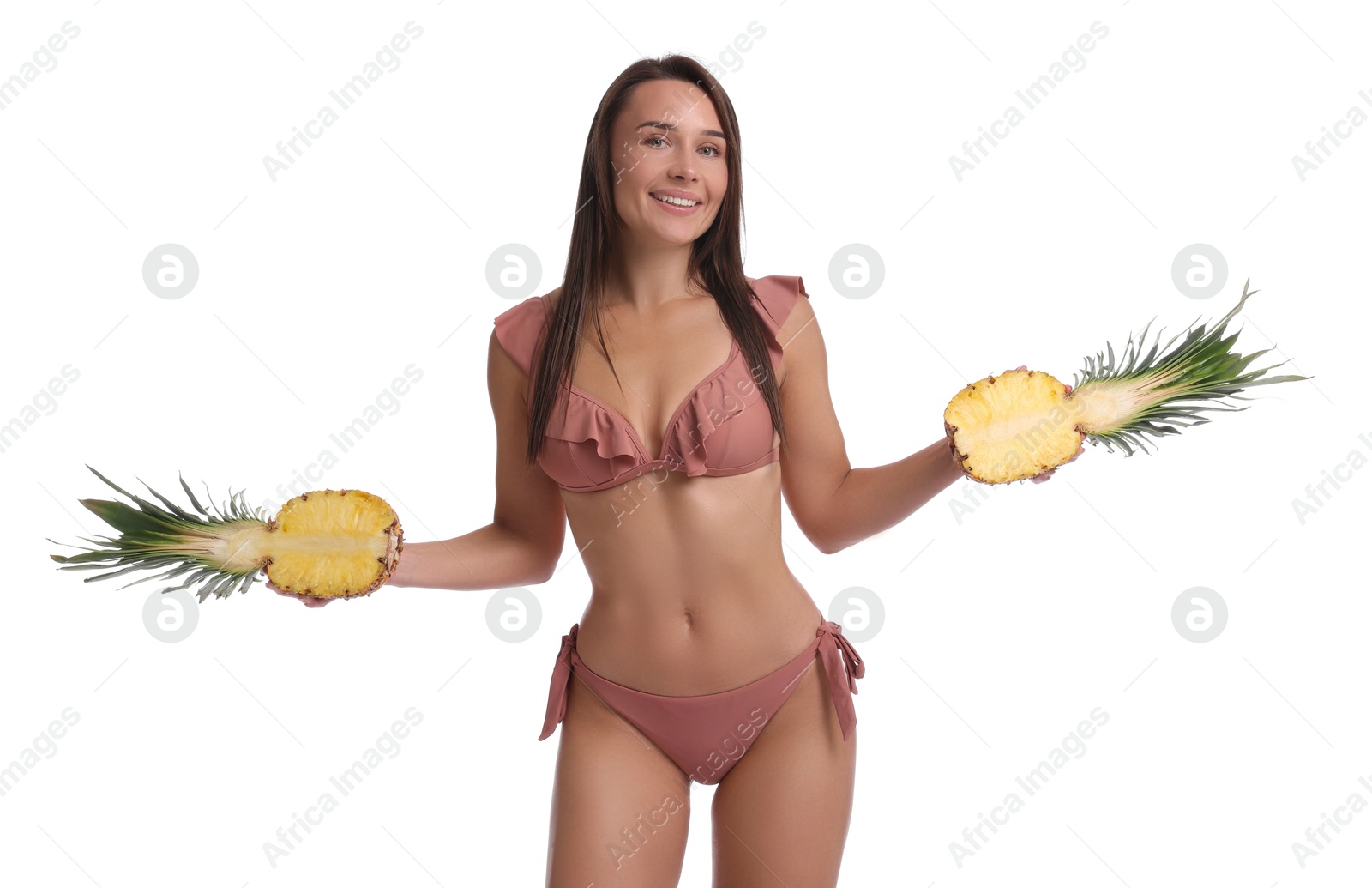 Photo of Attractive woman in bikini with halves of pineapple on white background