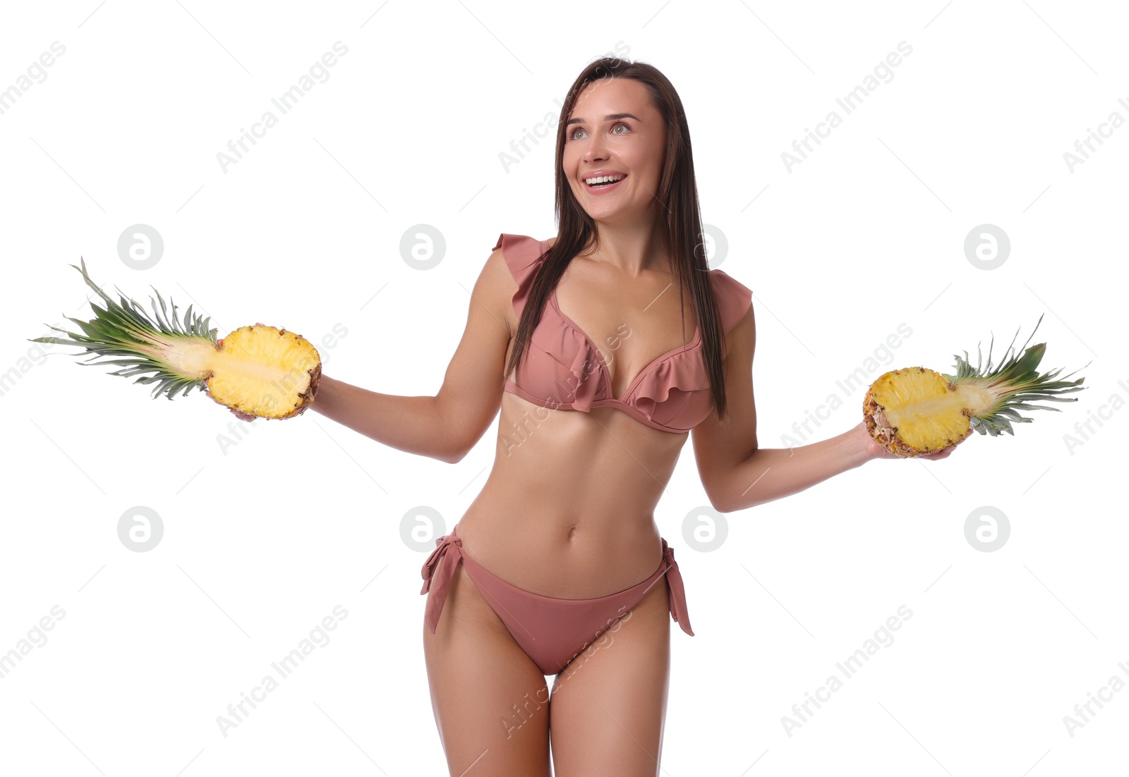 Photo of Attractive woman in bikini with halves of pineapple on white background