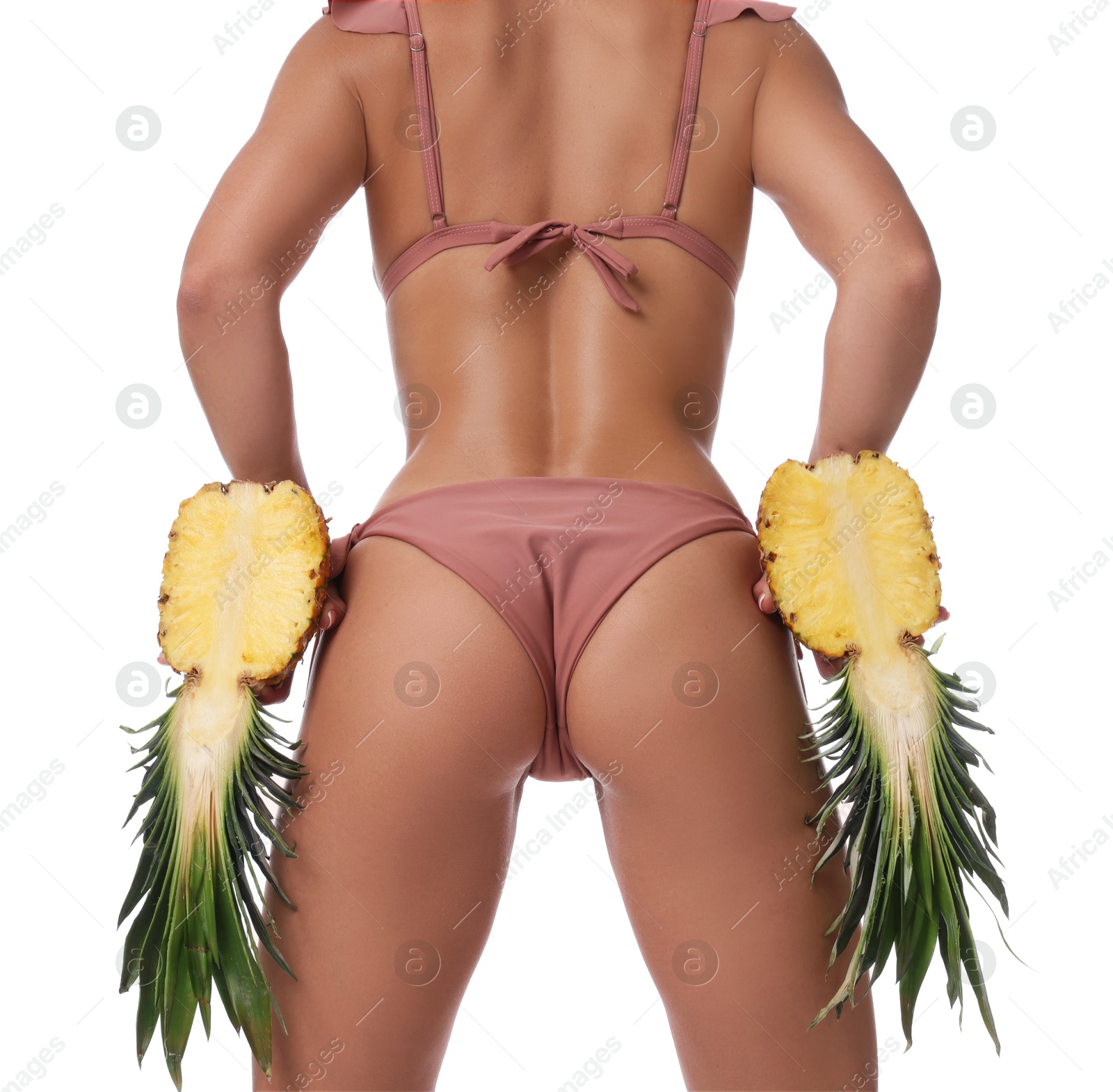 Photo of Woman in bikini with halves of pineapple on white background, closeup