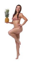 Photo of Woman in bikini with fresh pineapple on white background