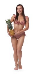 Woman in bikini with fresh pineapple on white background