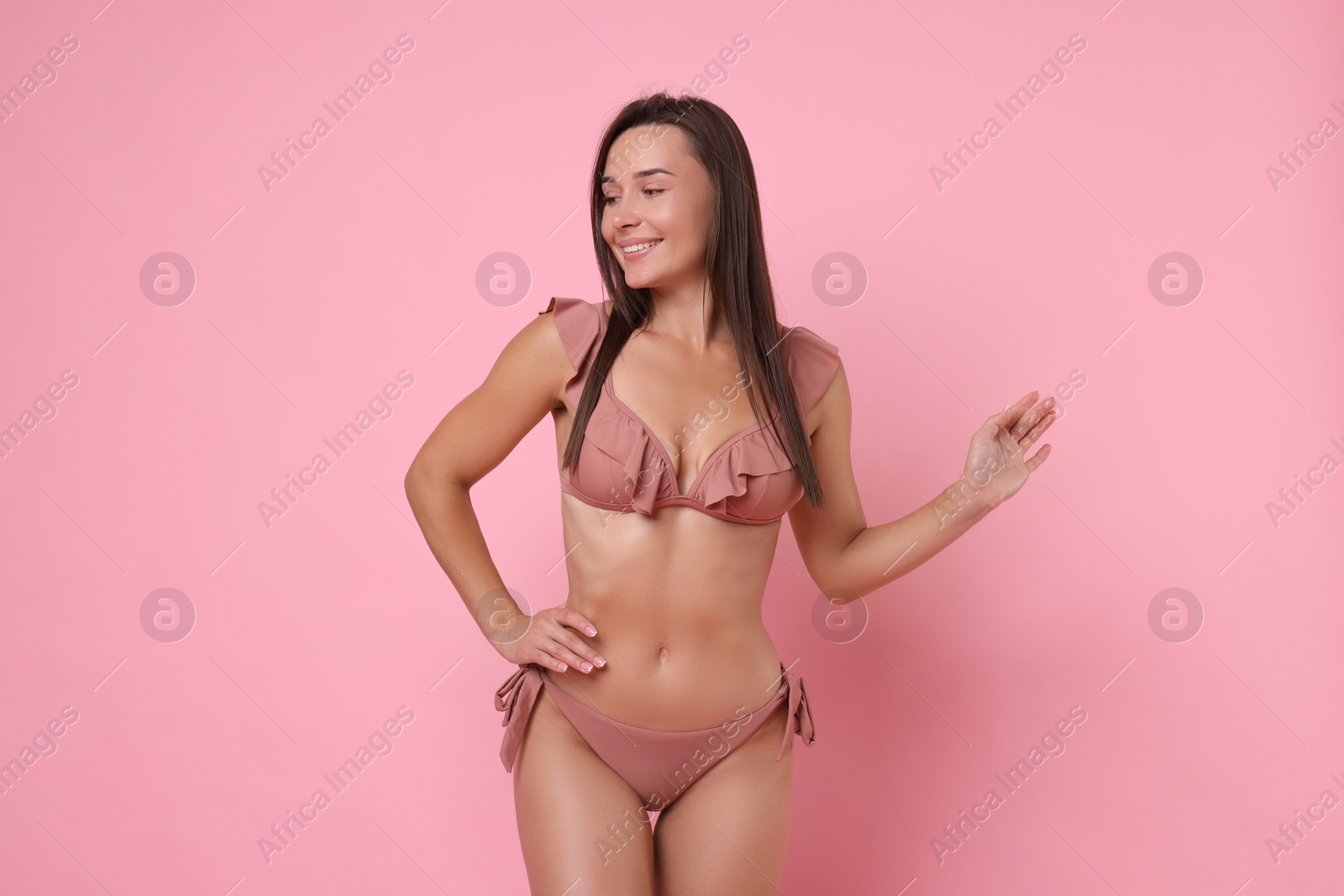 Photo of Woman in stylish bikini on pink background