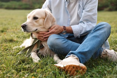 Man with cute Golden Retriever dog on spring day, closeup