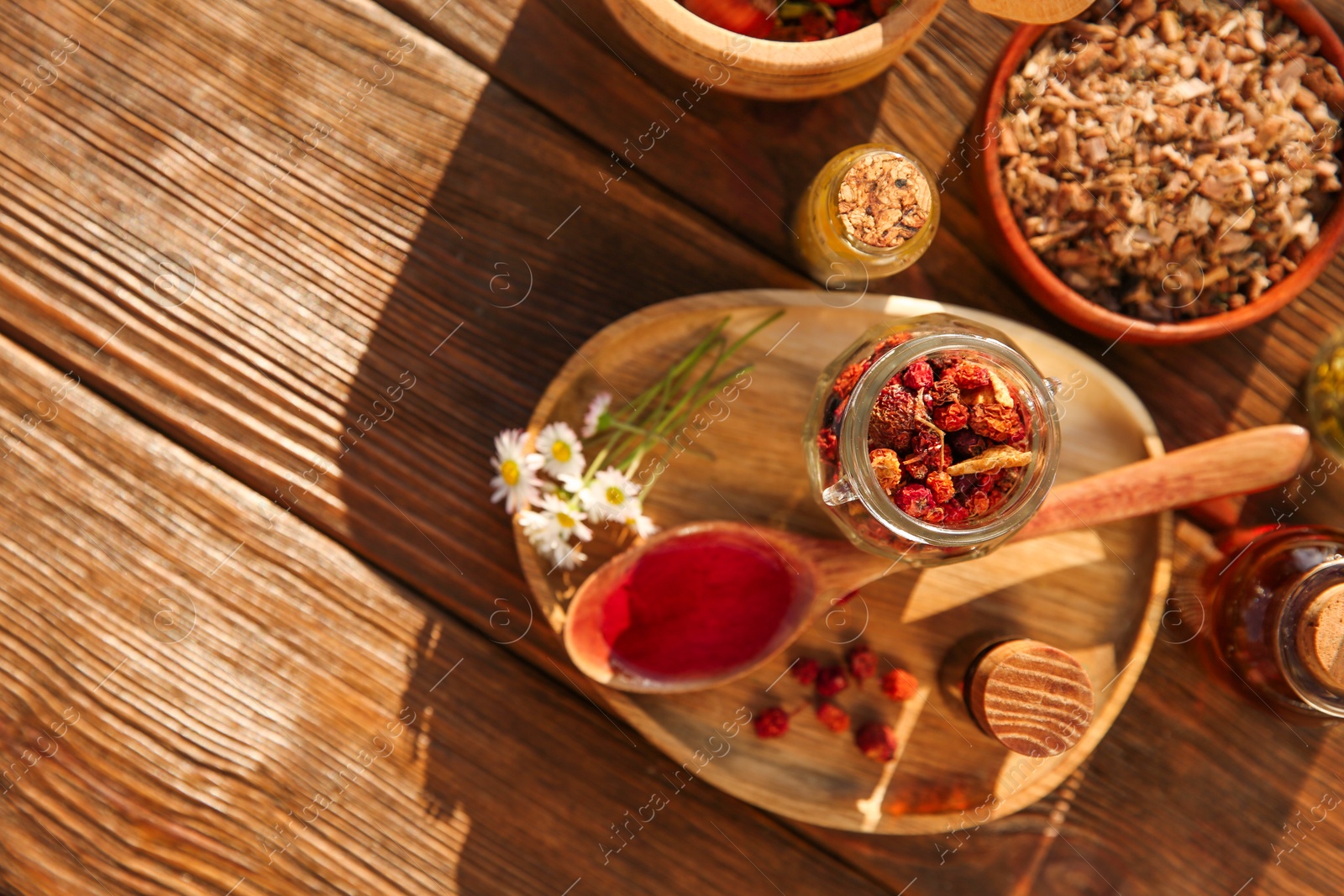 Photo of Tincture and different ingredients on wooden table, top view. Space for text