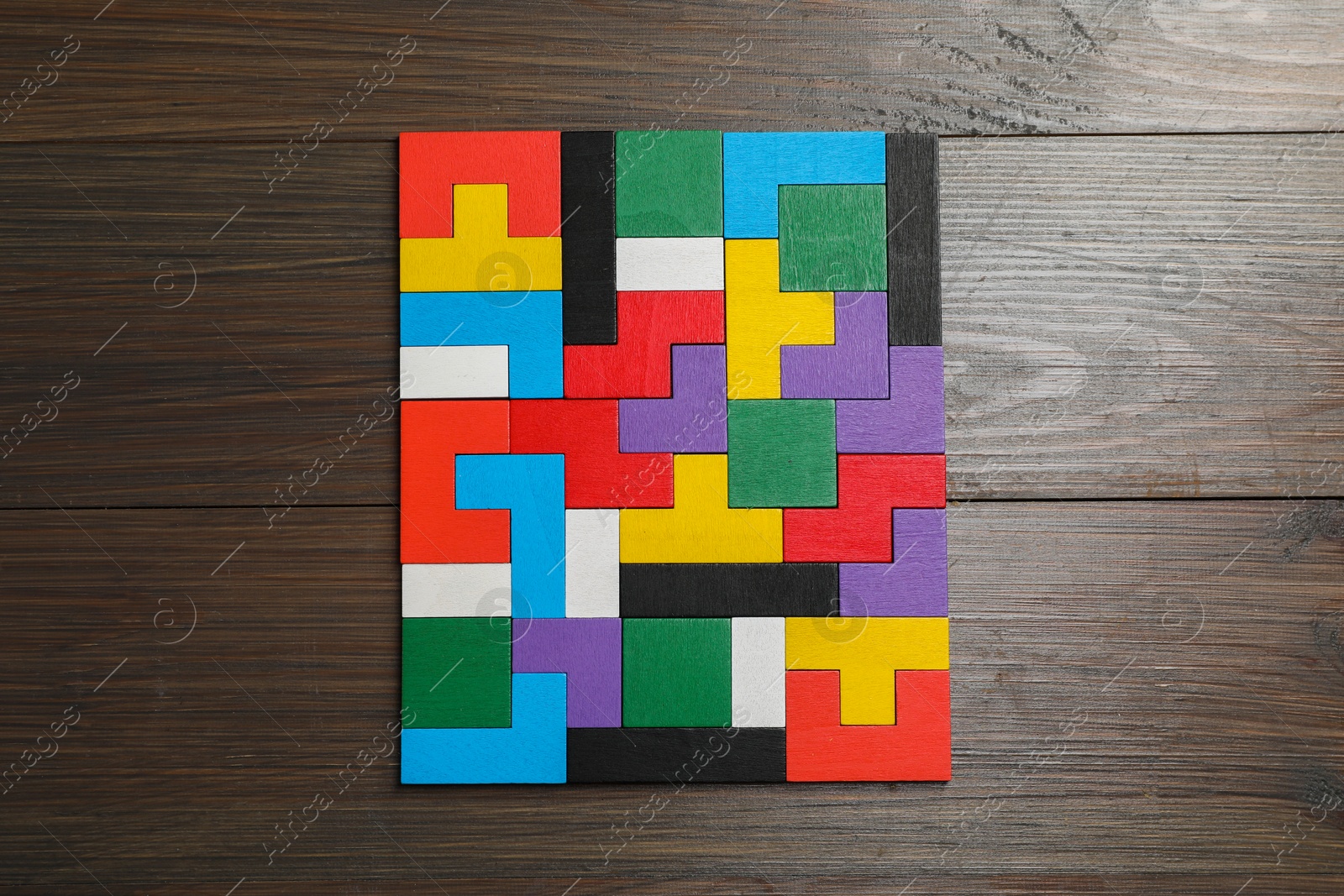 Photo of Colorful puzzle pieces on wooden table, top view