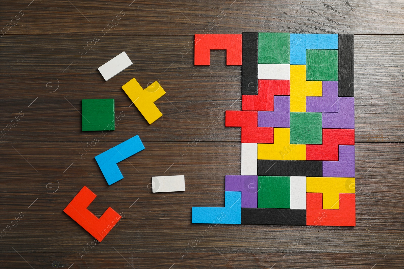 Photo of Colorful puzzle pieces on wooden table, top view