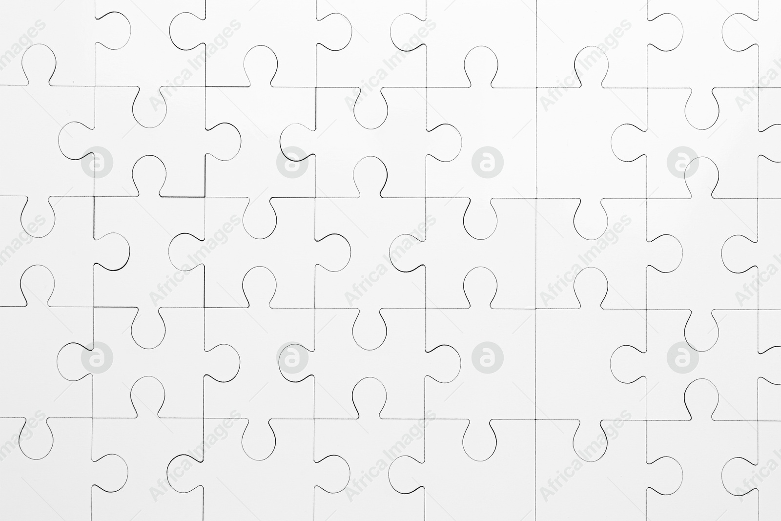 Photo of White puzzle as background, top view. Intellectual game