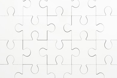 White puzzle as background, top view. Intellectual game