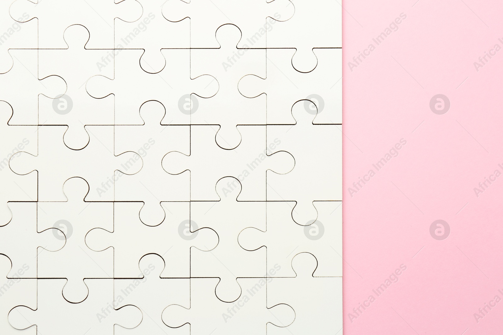 Photo of White puzzle on pink background, top view