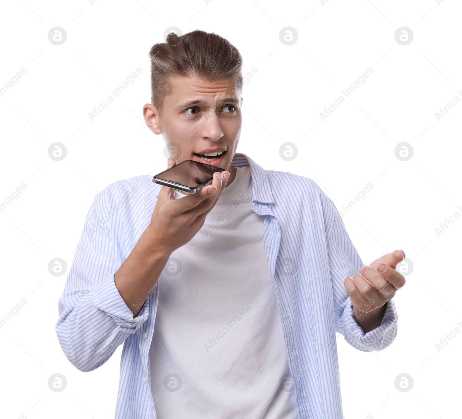 Photo of Young man recording voice message via smartphone on white background