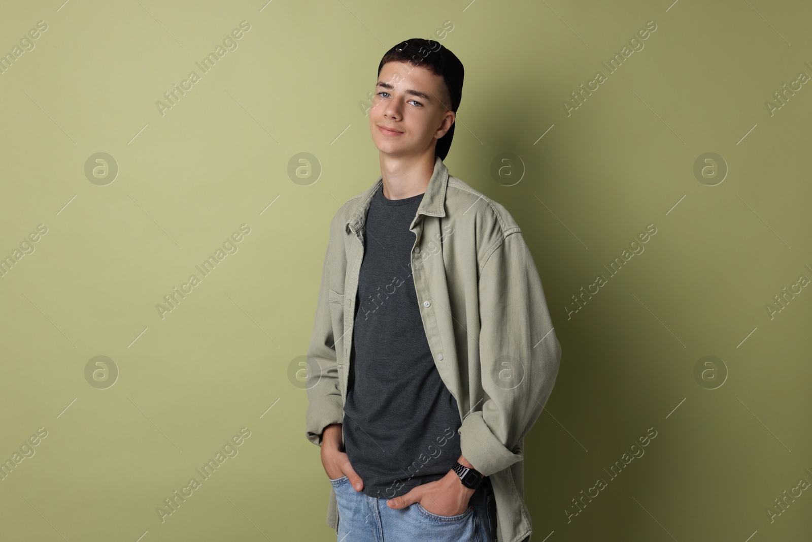 Photo of Portrait of teenage boy on green background