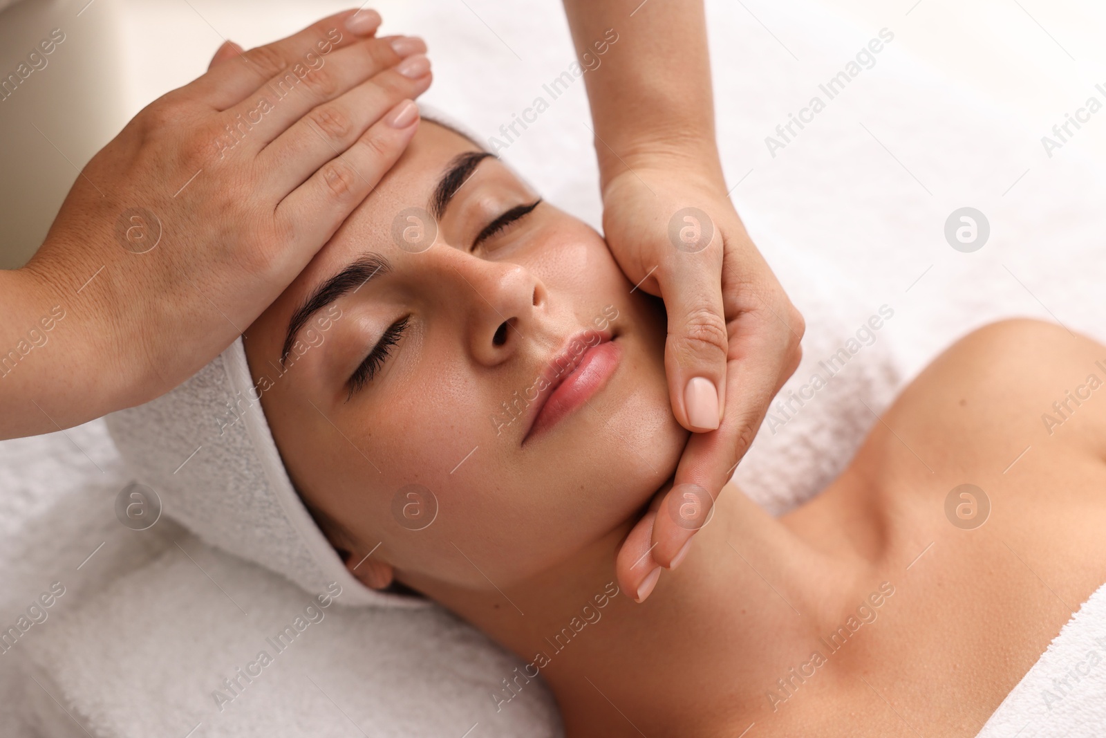 Photo of Attractive woman enjoying face massage, closeup. Beauty procedure