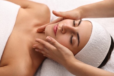 Photo of Attractive woman enjoying face massage, closeup. Beauty procedure