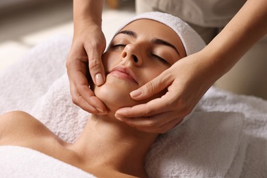 Photo of Attractive woman enjoying face massage, closeup. Beauty procedure