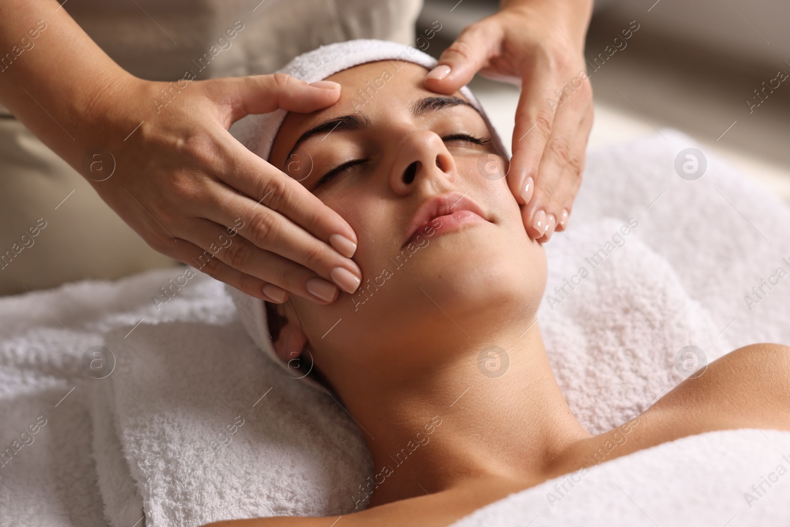 Photo of Attractive woman enjoying face massage, closeup. Beauty procedure