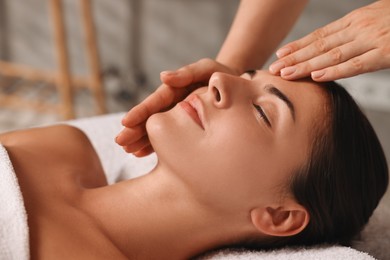 Photo of Attractive woman enjoying face massage, closeup. Beauty procedure