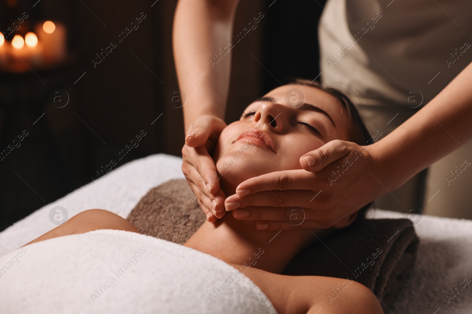 Photo of Attractive woman enjoying face massage, closeup. Beauty procedure