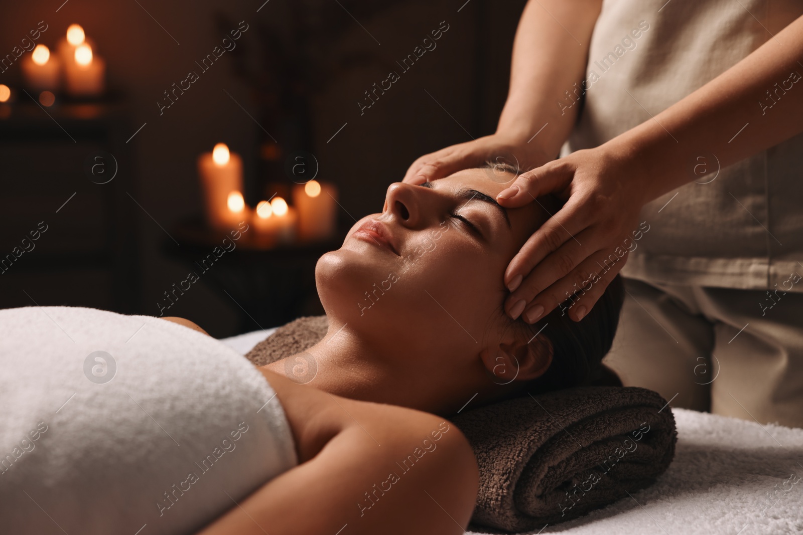 Photo of Attractive woman enjoying face massage, closeup. Beauty procedure