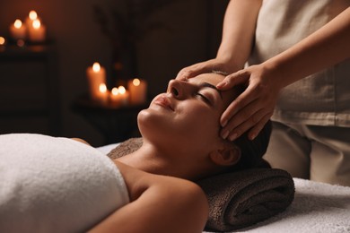 Photo of Attractive woman enjoying face massage, closeup. Beauty procedure