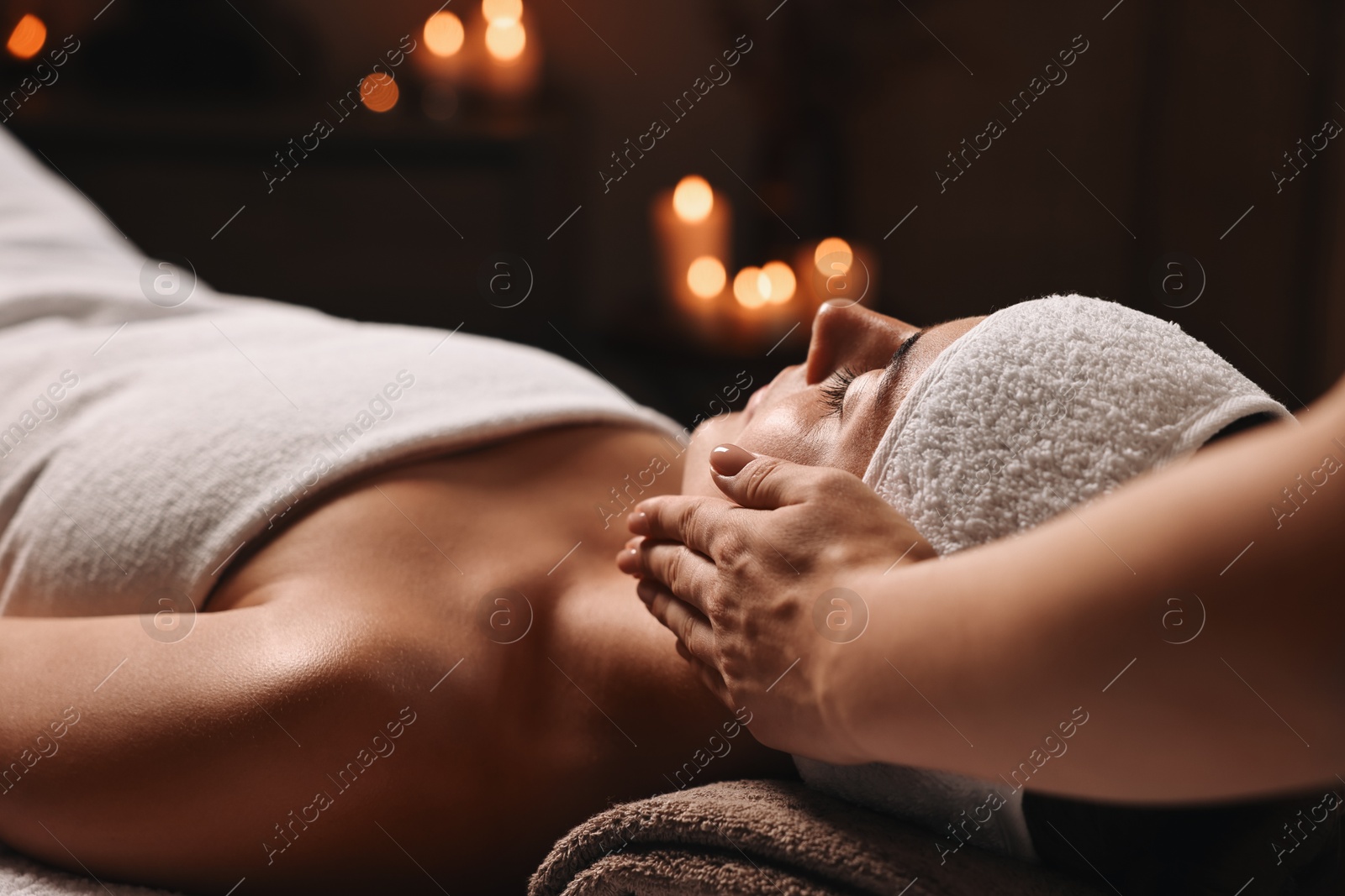 Photo of Attractive woman enjoying face massage, closeup. Beauty procedure