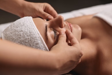 Photo of Attractive woman enjoying face massage, closeup. Beauty procedure