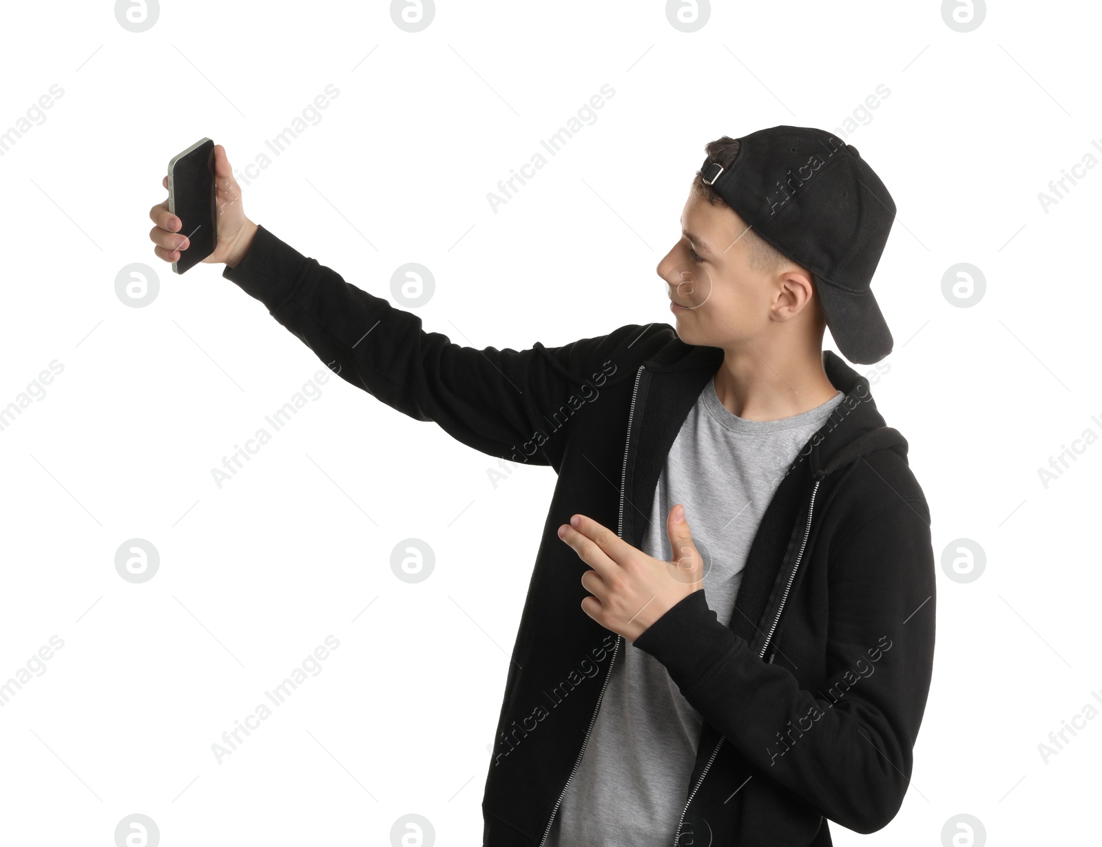 Photo of Teenage boy taking selfie on white background