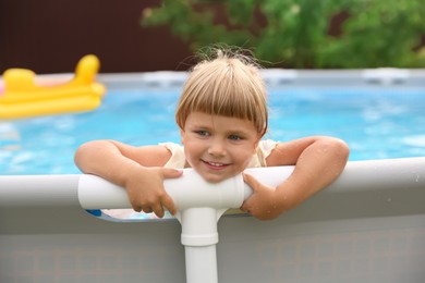 Photo of Happy daughter and her father resting in swimming pool