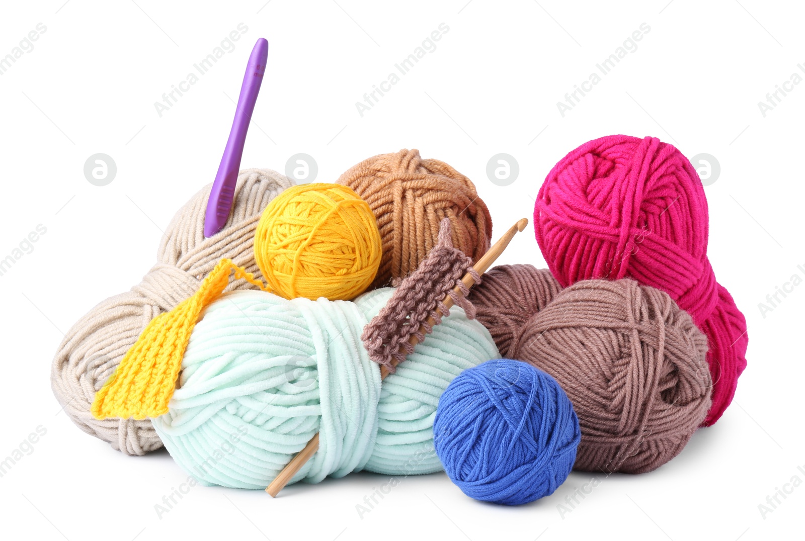 Photo of Different yarns, pattern samples and crochet hooks isolated on white