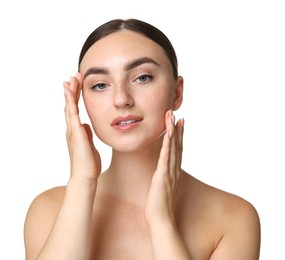 Beautiful young woman doing facial massage on white background